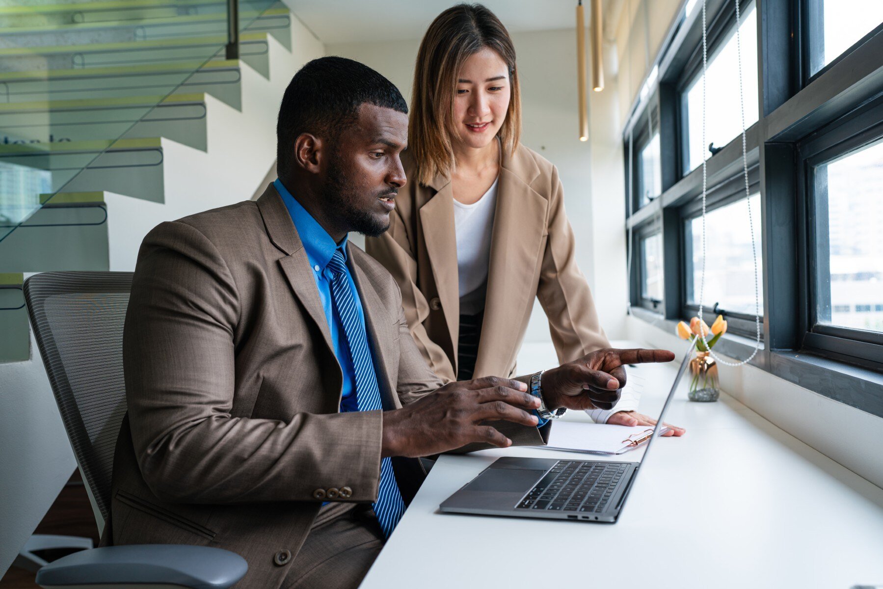 two-happy-business-woman-and-man-using-laptop-work